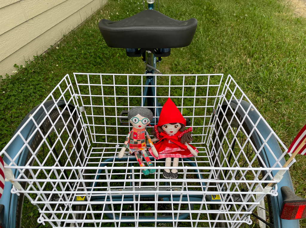 The Grandma and Little Red dolls are sitting in my trike basket waiting to go for a ride! 