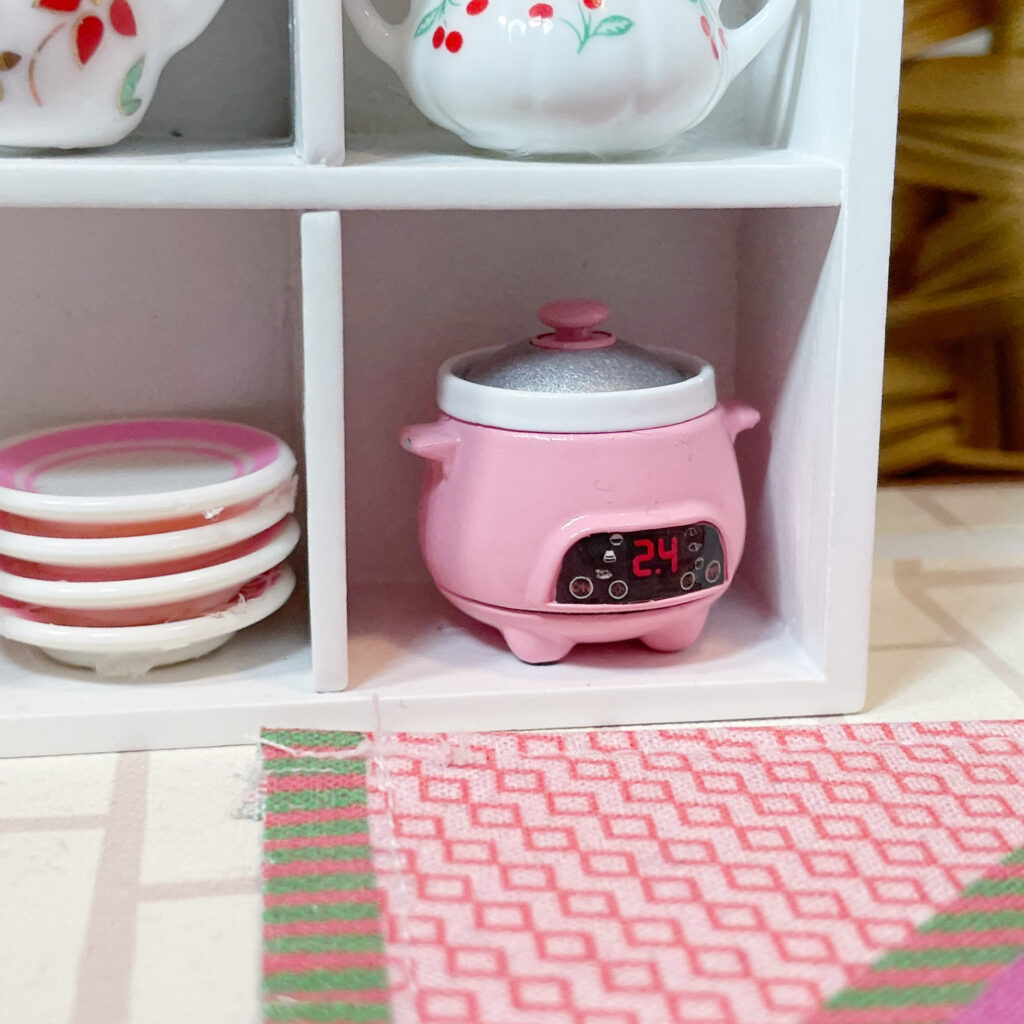 A miniature pink crock pot.