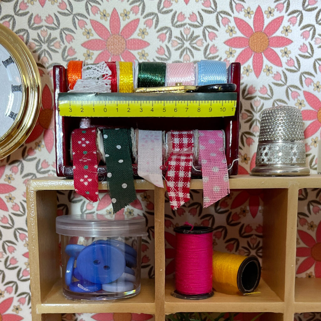 A miniature ribbon station with various decorative spools of ribbon. 