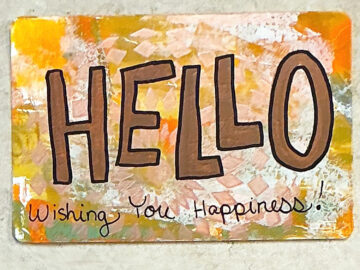 A postcard that reads Hello Wishing you Happiness!