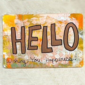 A postcard that reads Hello Wishing you Happiness!